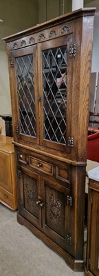 Lot 886 - An antique oak carved two-part corner cupboard,...