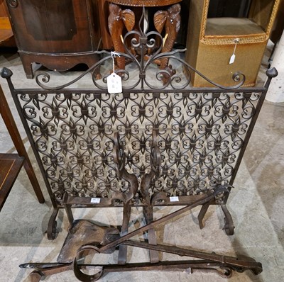 Lot 911 - An Arts and Crafts wrought iron fire guard...