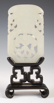 Lot 587 - A Chinese pale celadon jade panel, carved and...