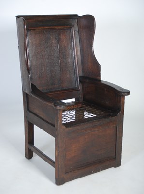 Lot 27 - An early 18th century oak lambing chair, the...