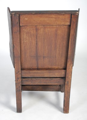Lot 27 - An early 18th century oak lambing chair, the...