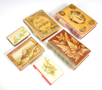 Lot 167 - A collection of six Mauchline Ware bound books,...