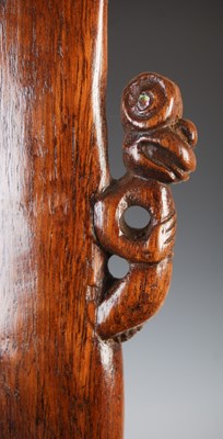Lot 143 - A Māori wood Patu, carved with stylised figure...
