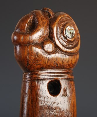 Lot 143 - A Māori wood Patu, carved with stylised figure...