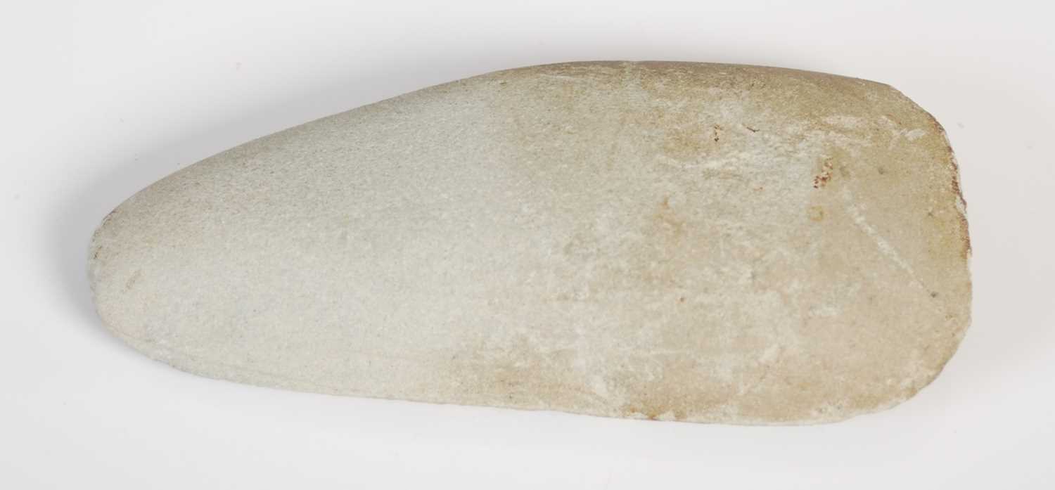 Lot 128 - A Neolithic polished stone hand axe, 11.5cm long.