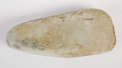Lot 128 - A Neolithic polished stone hand axe, 11.5cm long.
