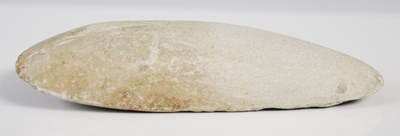 Lot 128 - A Neolithic polished stone hand axe, 11.5cm long.