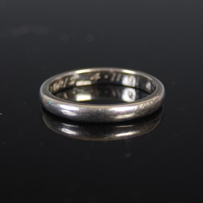 Lot 484 - A platinum wedding ring, of plain circular...