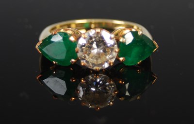 Lot 524 - An 18ct gold, emerald and diamond three stone...