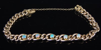 Lot 512 - A yellow metal and opal curb link bracelet,...