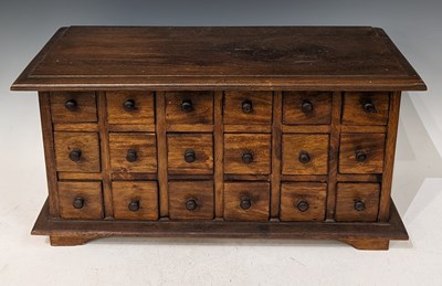 Lot 772 - A stained wood table top chest of eighteen...