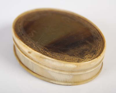 Lot 268 - A pressed horn oval snuff box, the pull-off...