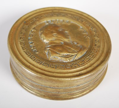 Lot 219 - A cast brass circular snuff box, the pull-off...