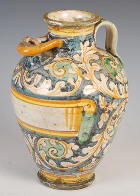 Lot 554 - An antique Maiolica pottery flagon, decorated...