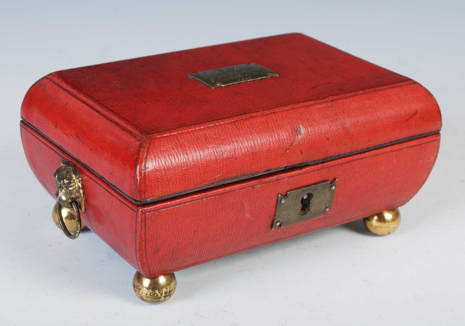 Lot 136 - A George III red leather sarcophagus shaped...