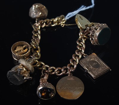 Lot 51 - A 9ct gold charm bracelet suspending seven...