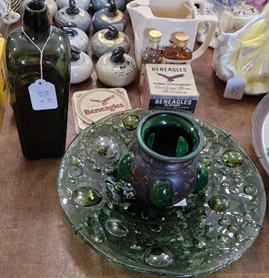 Lot 519 - An antique green glass bottle, 24cm high;...