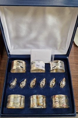 Lot 369 - A cased set of six napkin rings and six duck...