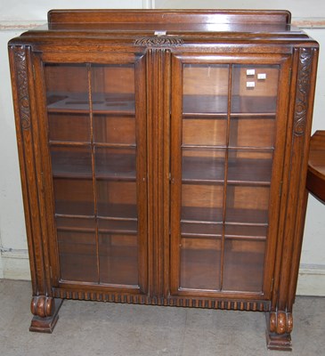 Lot 617 - An Early 20th century oak display cabinet with...