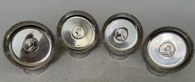 Lot 126 - Four assorted white metal coin set dishes,...