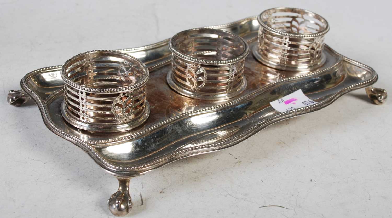 Lot 130 - A George III silver desk stand, of shaped