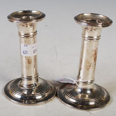 Lot 132 - A pair of Edwardian silver candlesticks,...