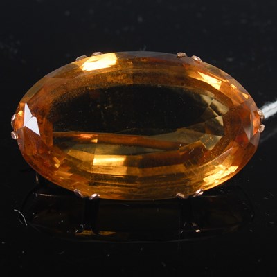 Lot 222 - A yellow metal mounted oval facet cut citrine...