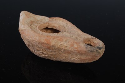 Lot 220 - An antique pottery oil lamp, possibly Roman,...