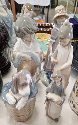 Lot 524 - Three Lladro figures to include a girl holding...