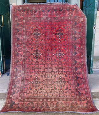 Lot 993 - A Persian rug, 20th century, the madder ground...