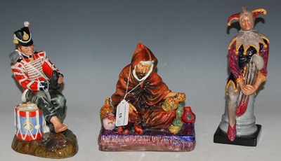 Lot 15 - Three Royal Doulton figures to include 'The...