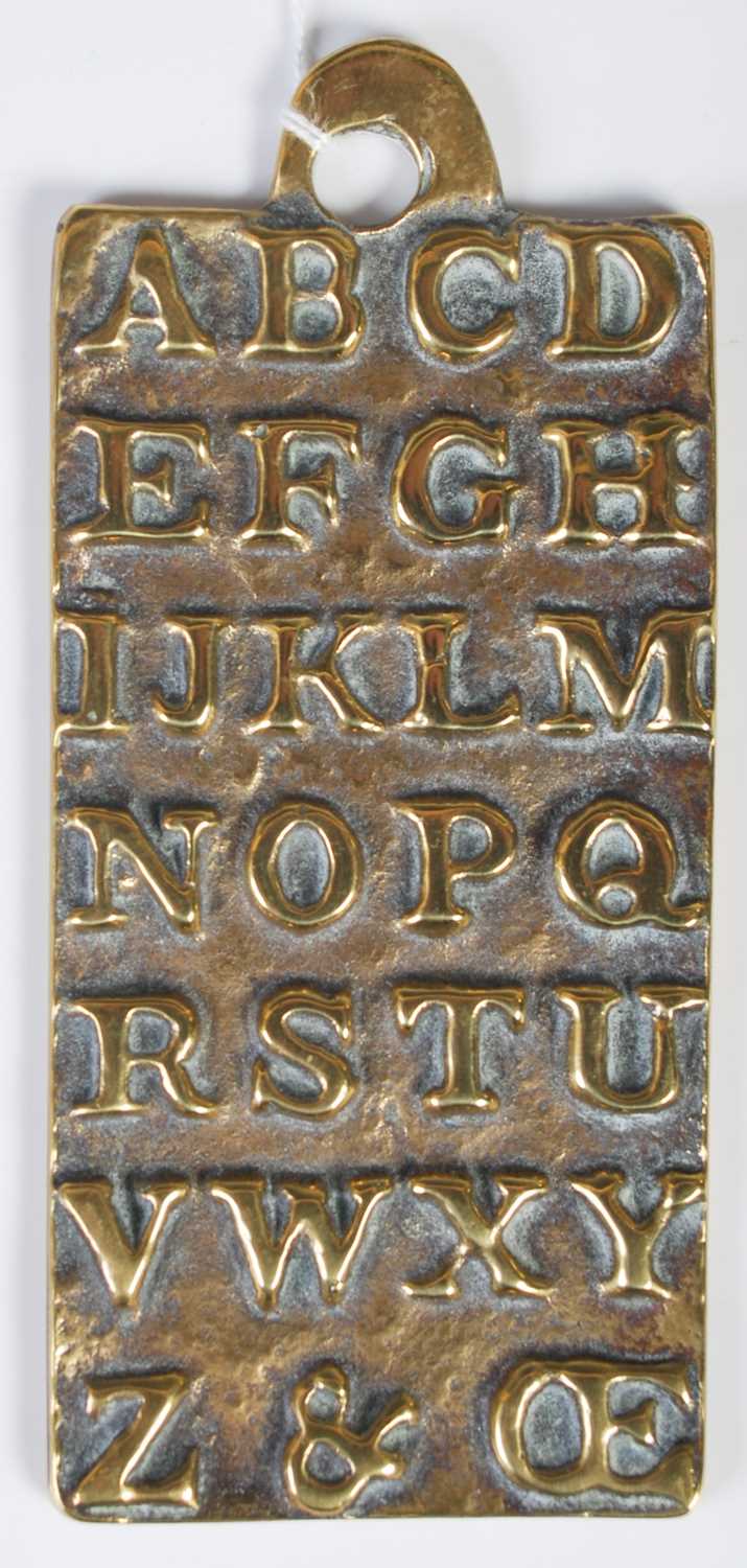 Lot 303 - An antique brass alphabet plaque teaching aid,...