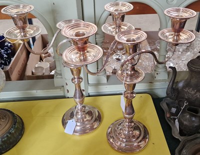 Lot 476 - A pair of EPNS three light candelabra, the...