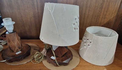 Lot 856 - Two stained oak table lamps and shades.