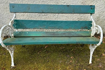 Lot 894 - A cast iron and wood garden bench, the ends...