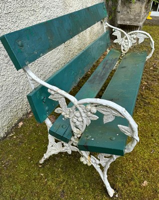 Lot 894 - A cast iron and wood garden bench, the ends...