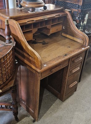 Lot 865 - A vintage oak roll-top desk with serpentine...