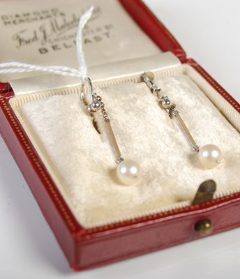 Lot 322 - A pair of white metal and pearl drop earrings...