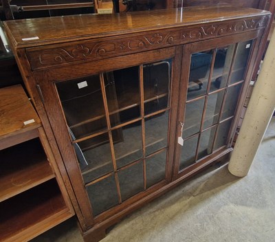 Lot 882 - An early 20th century oak bookcase with two...