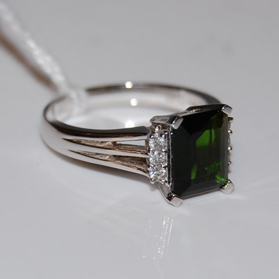 Lot 45 - An Art Deco style 15ct white gold, green stone...
