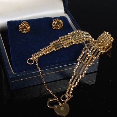 Lot 312 - A 9ct gold gate link bracelet with heart...