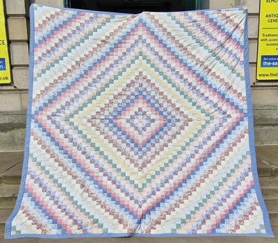 Lot 799 - A vintage patchwork quilt.