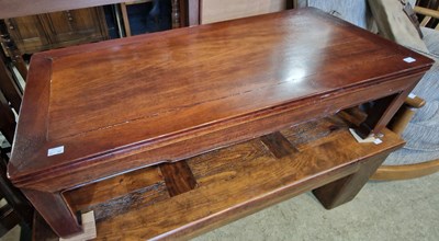 Lot 809 - A Chinese darkwood Kang table on four square...