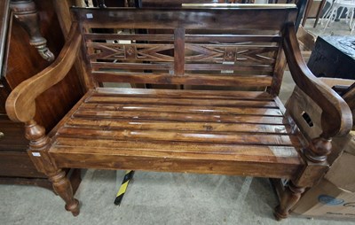 Lot 934 - A stained wood hall bench with slatted back...