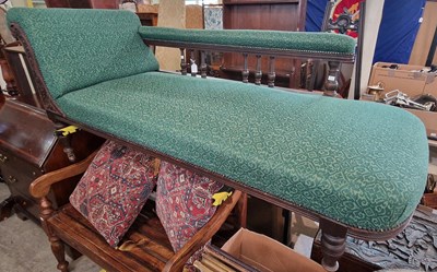 Lot 932 - A Victorian oak chaise longue with green...