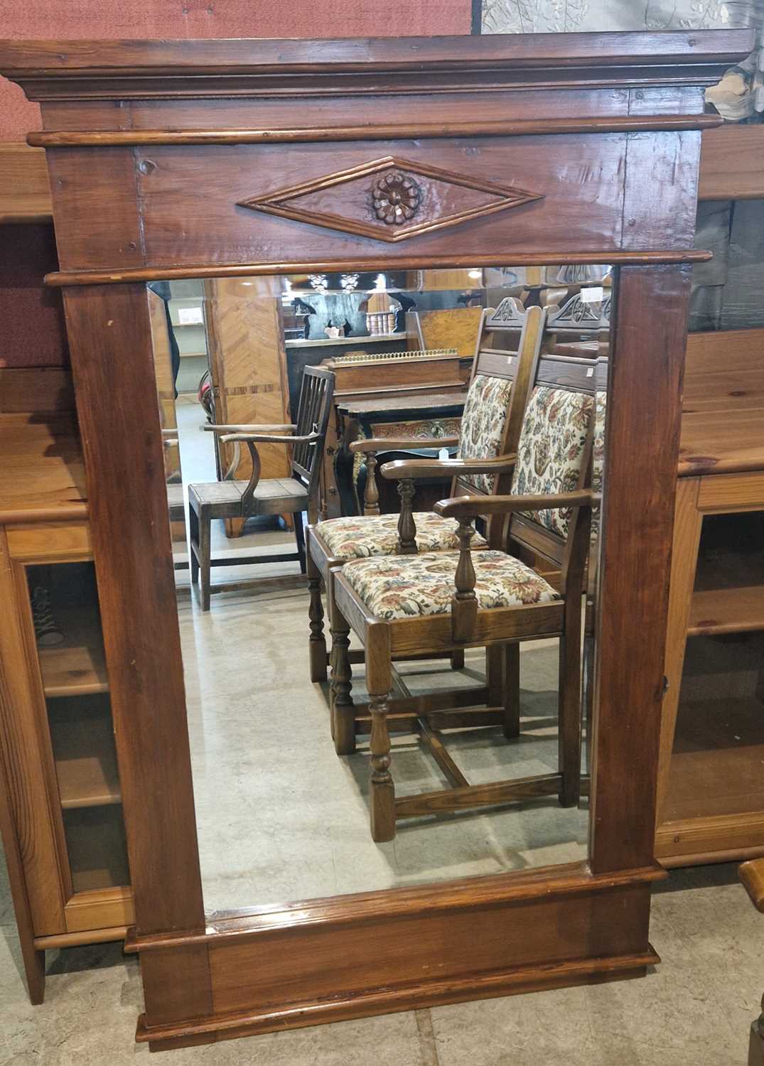 Lot 961 - A stained wood wall mirror enclosing a