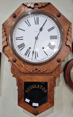 Lot 825 - A vintage oak wall clock, the black and white...