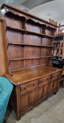 Lot 831 - An ercol darkwood dresser, the upright back...