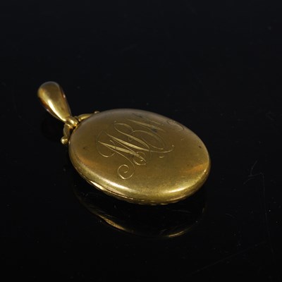 Lot 77 - A Victorian yellow metal oval mourning locket,...