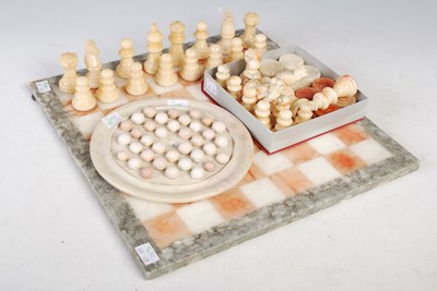 Lot 501 - A hardstone chessboard and chess pieces...